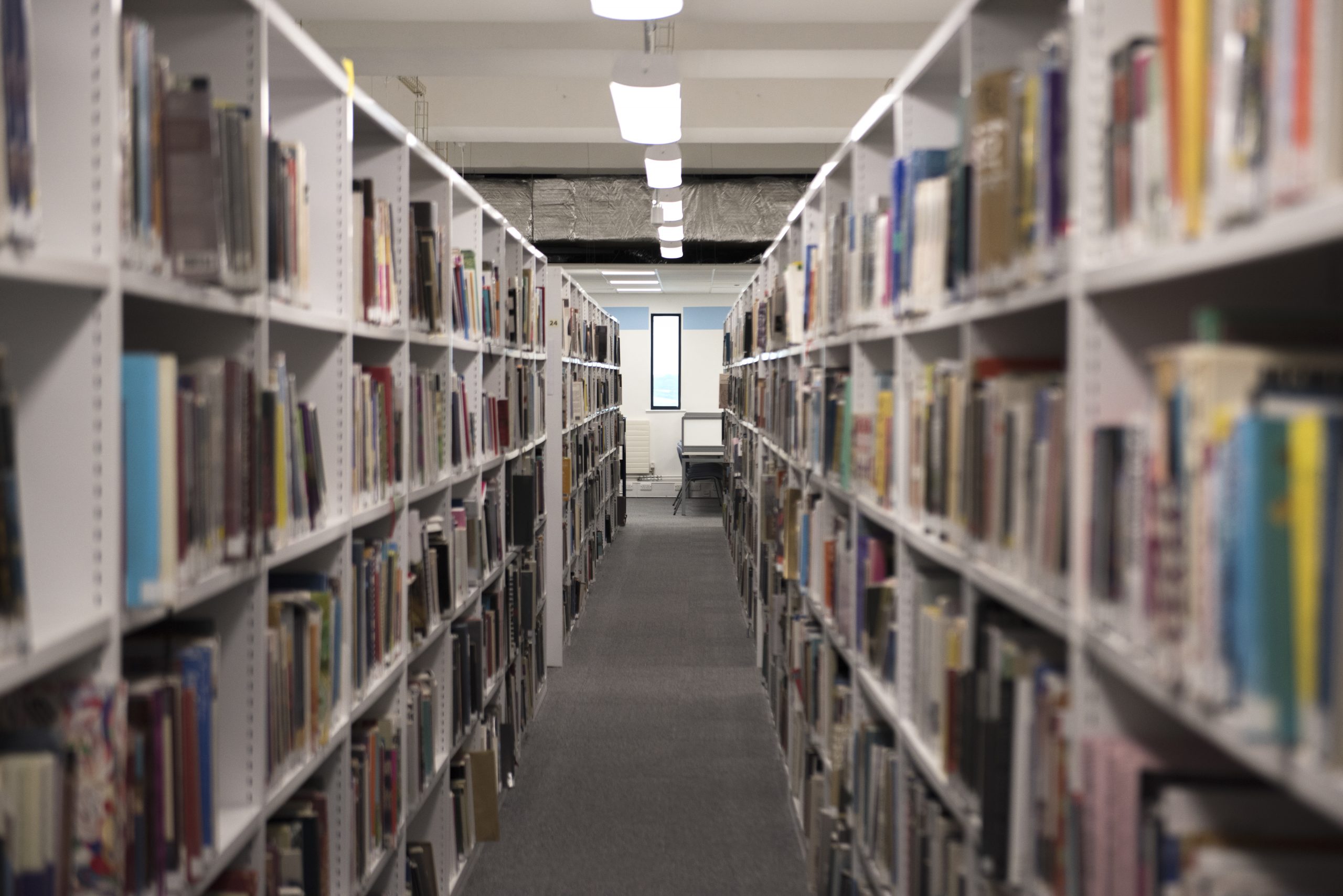 View of Penryn Campus Library Shelves filled with books.
