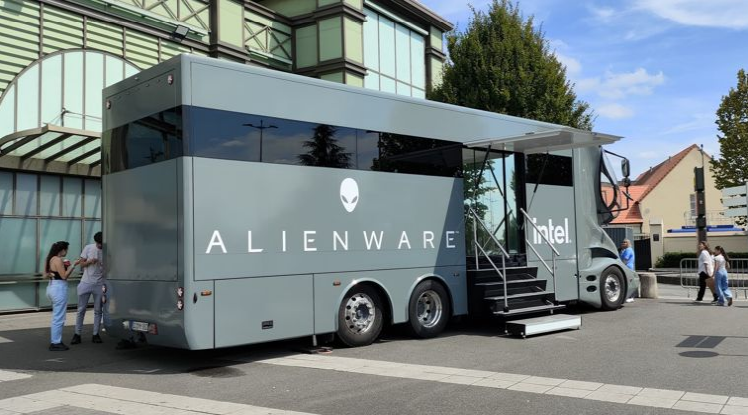 Image of a large, futuristic looking grey tour bus with Alienware Intel written on it.