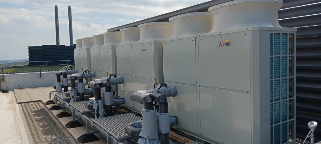 A photograph of the four air source heat pumps in position on the roof of the Stella Turk building.